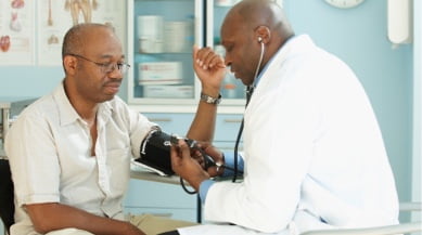 doctor taking patient's blood pressure image