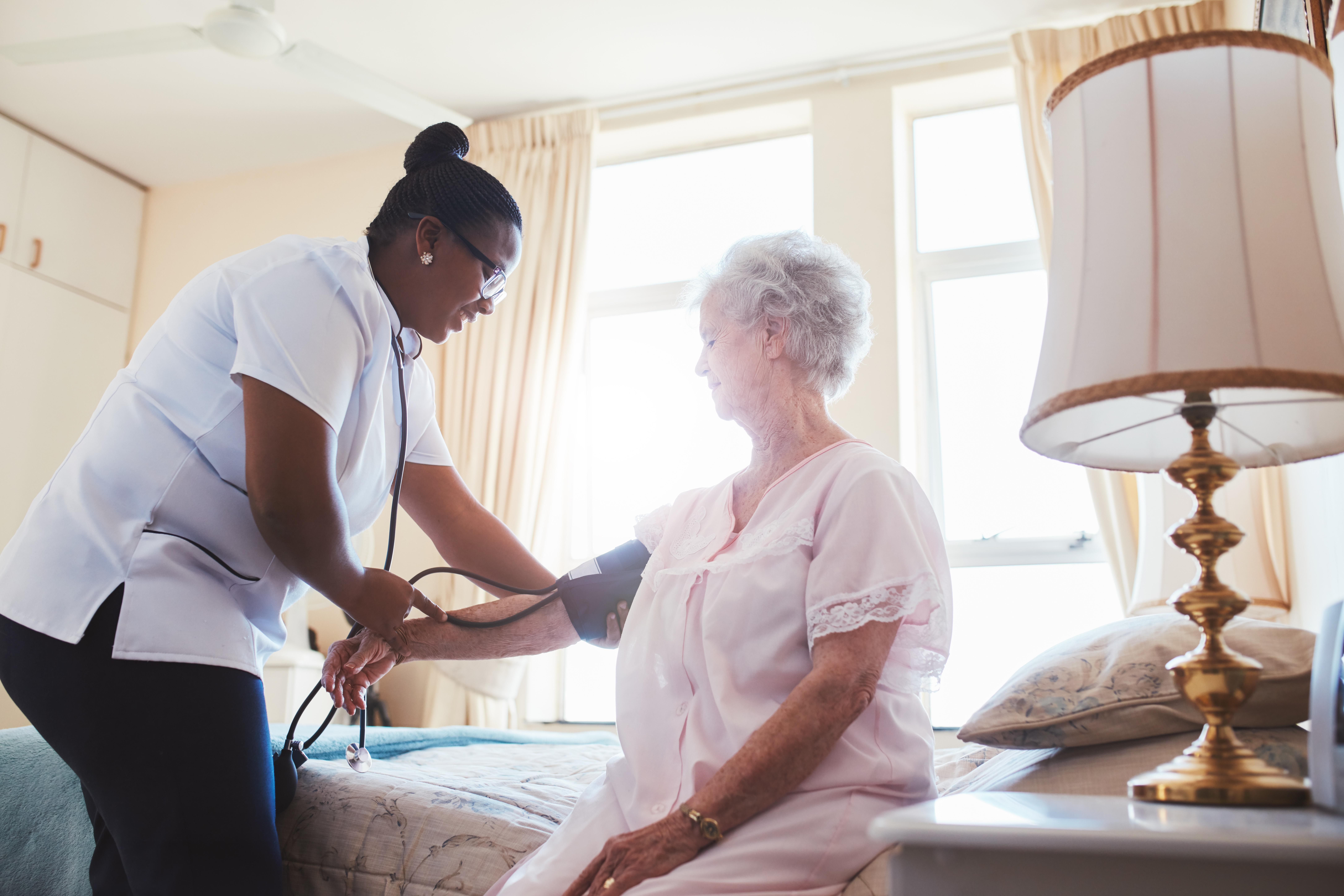 doctor taking patient's blood pressure image